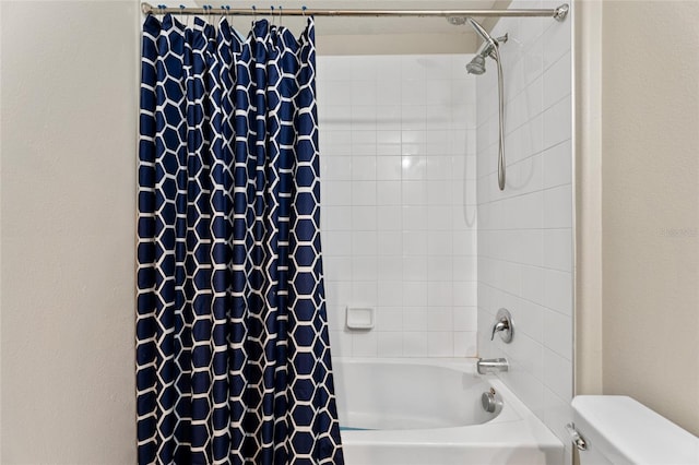 bathroom featuring shower / bath combo and toilet