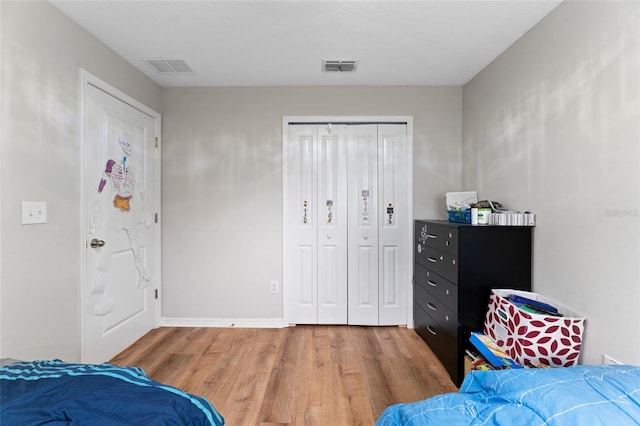 bedroom with a closet and wood-type flooring