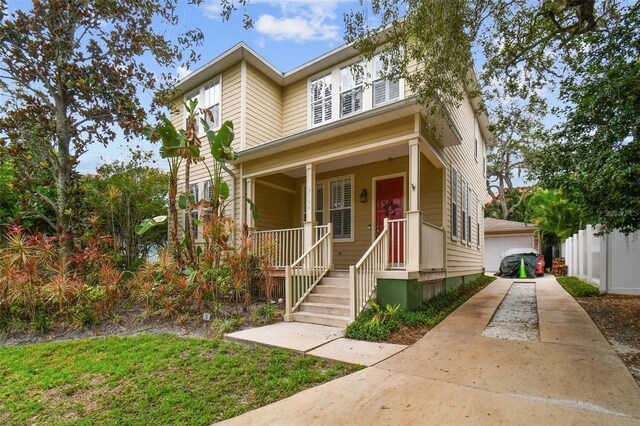 view of property featuring a porch and a garage