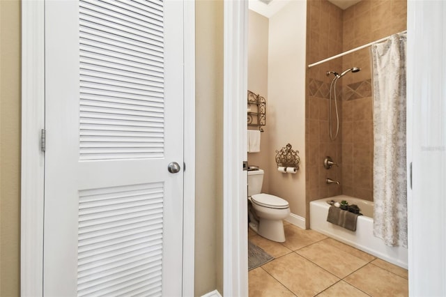 full bathroom featuring toilet, shower / bath combination with curtain, and tile patterned floors