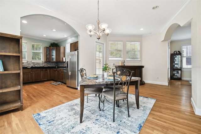 dining space with arched walkways and plenty of natural light