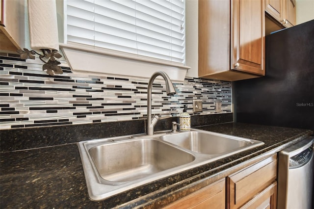 kitchen with dishwasher, backsplash, and a sink