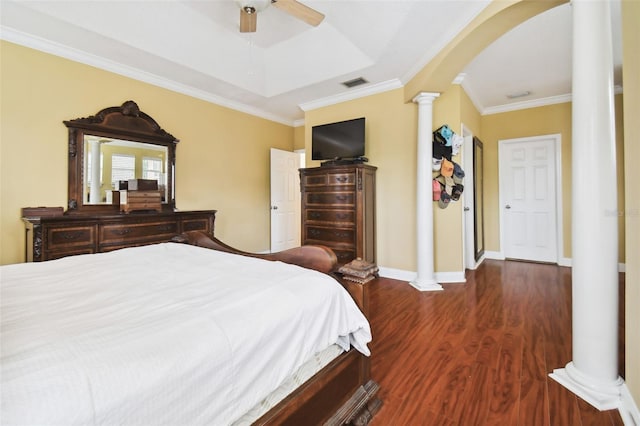 bedroom featuring dark wood-style floors, arched walkways, visible vents, ornamental molding, and ornate columns