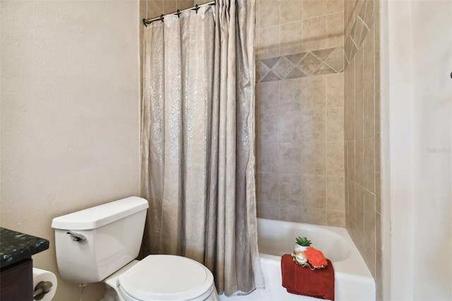 bathroom with toilet, shower / bath combo with shower curtain, and vanity