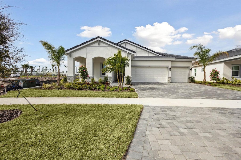 view of front of home featuring a garage and a front lawn