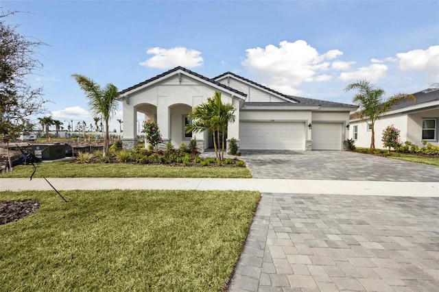 view of front of home featuring a garage and a front lawn