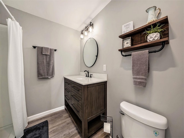 bathroom featuring toilet, curtained shower, wood-type flooring, and vanity