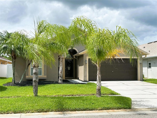 obstructed view of property with a front yard and a garage