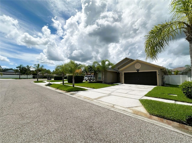 single story home featuring a front lawn and a garage