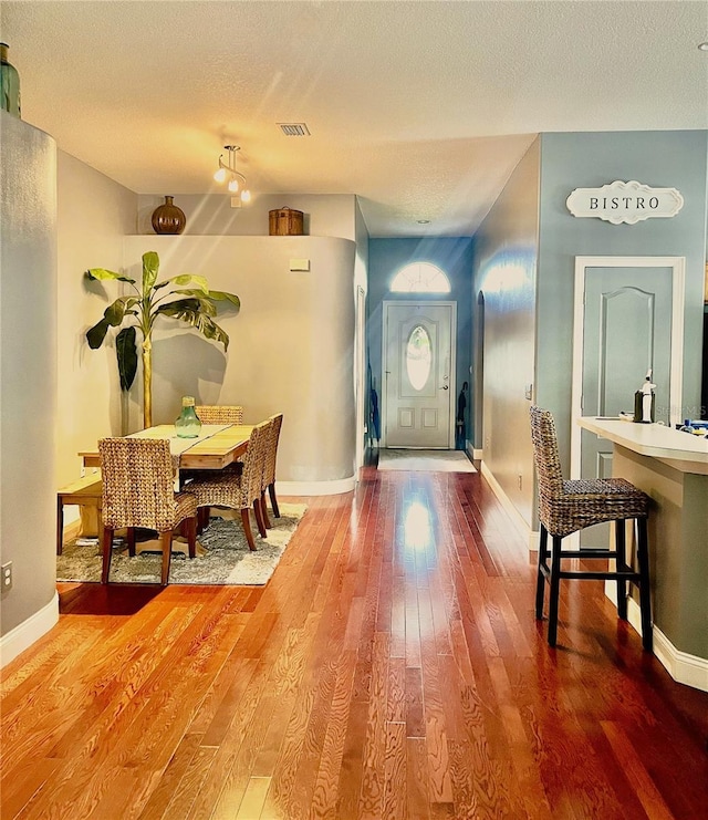 foyer with wood-type flooring and a textured ceiling