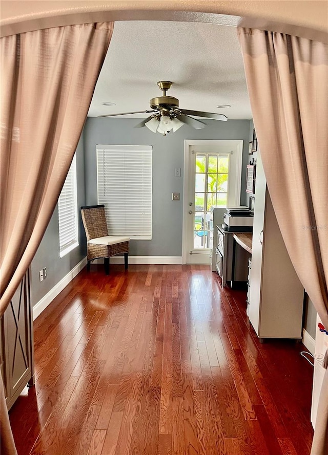 unfurnished room featuring ceiling fan, dark hardwood / wood-style flooring, and a textured ceiling