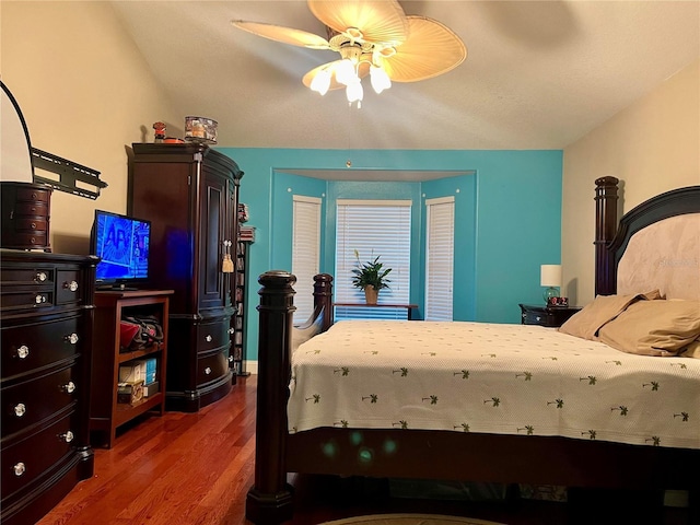 bedroom with dark hardwood / wood-style floors and ceiling fan