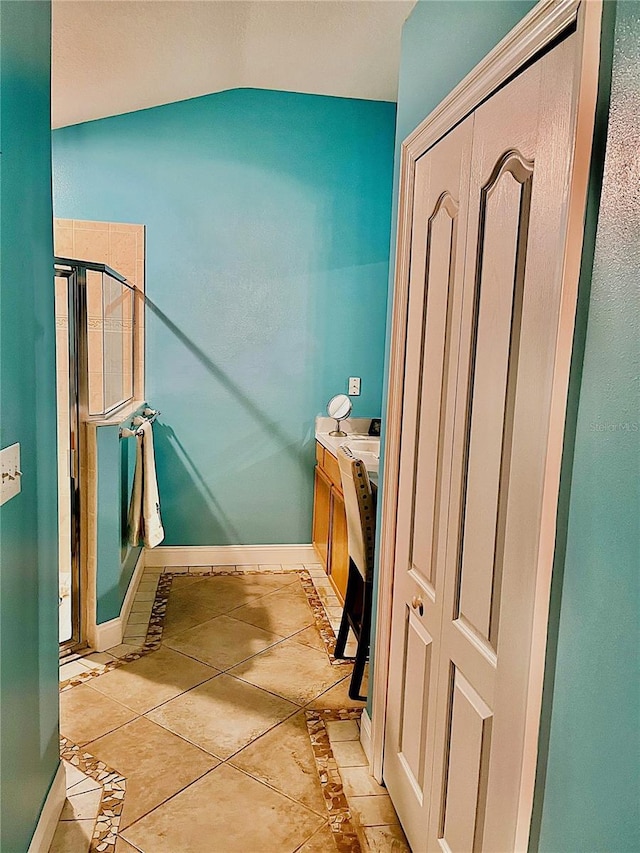 bathroom with tile patterned flooring and lofted ceiling