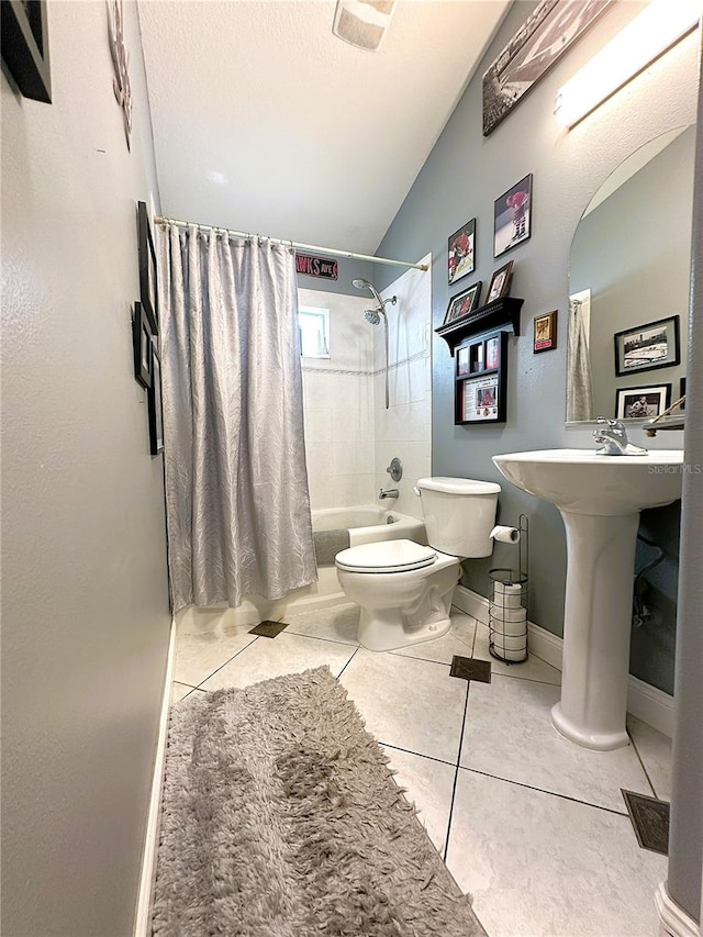 bathroom with tile patterned flooring, shower / bathtub combination with curtain, vaulted ceiling, and toilet