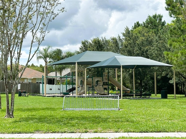 view of home's community with a playground and a lawn