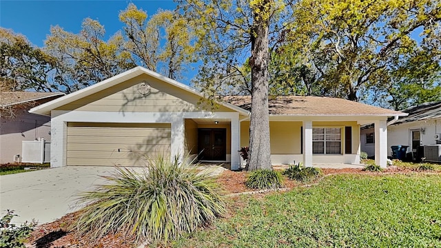 ranch-style home featuring brick siding, a front yard, central AC unit, driveway, and an attached garage