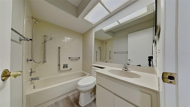 bathroom with shower / bathing tub combination, toilet, wood finished floors, and vanity