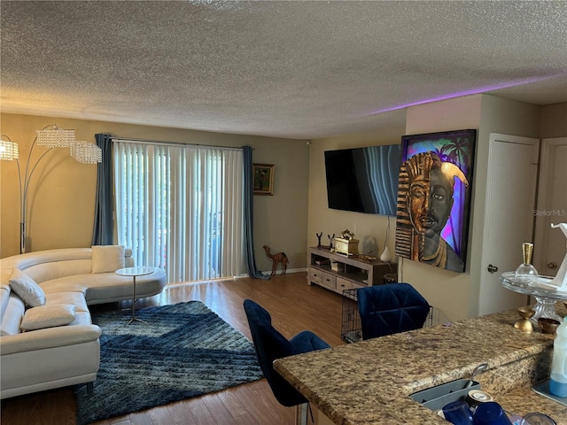 living room featuring hardwood / wood-style flooring and a textured ceiling