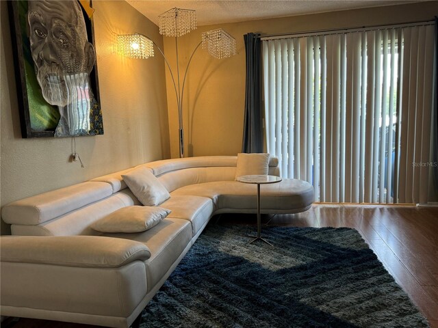 living room featuring an inviting chandelier and wood-type flooring