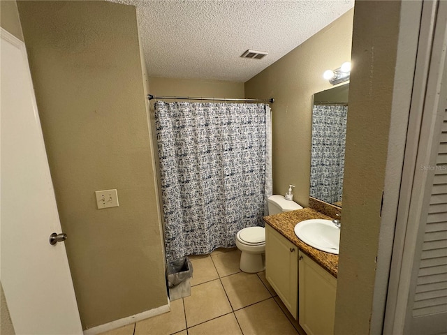 bathroom with tile floors, a textured ceiling, oversized vanity, and toilet