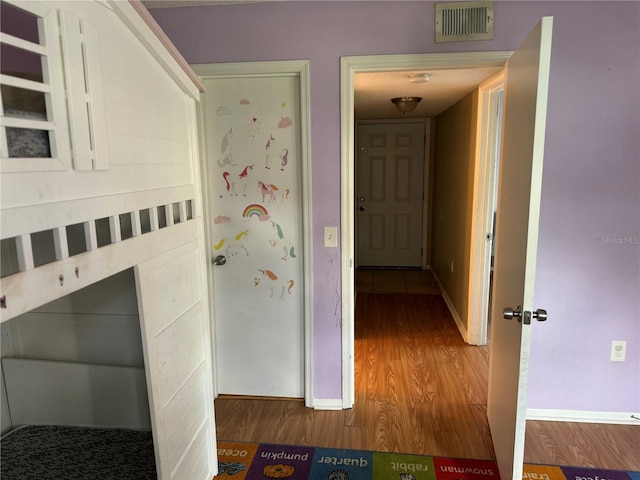 corridor with wood-type flooring