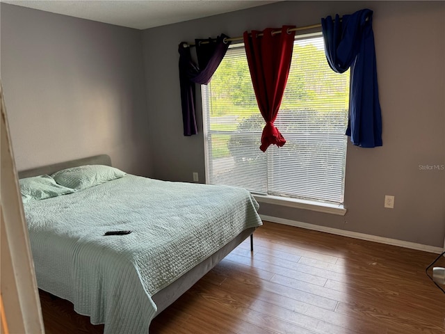 bedroom featuring dark hardwood / wood-style flooring