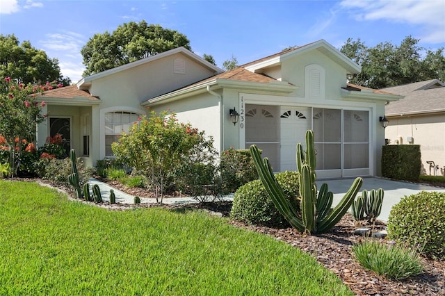 ranch-style house with a garage and a front lawn