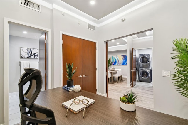 interior space with recessed lighting, visible vents, wood finished floors, and stacked washer and clothes dryer