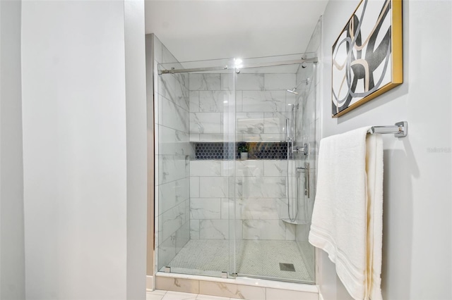 full bathroom featuring a marble finish shower