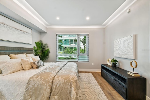 bedroom with ornamental molding, recessed lighting, baseboards, and wood finished floors