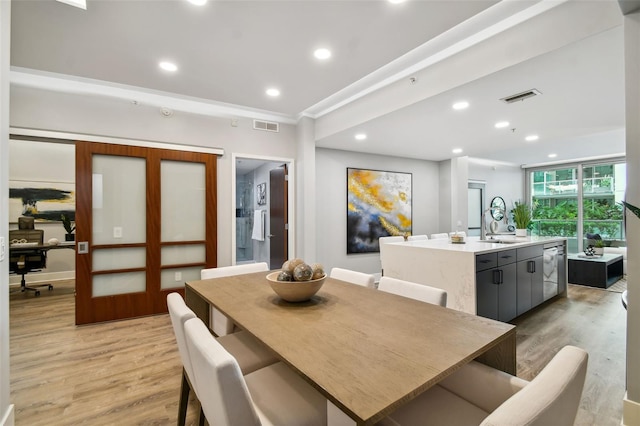 dining room with sink and light hardwood / wood-style floors