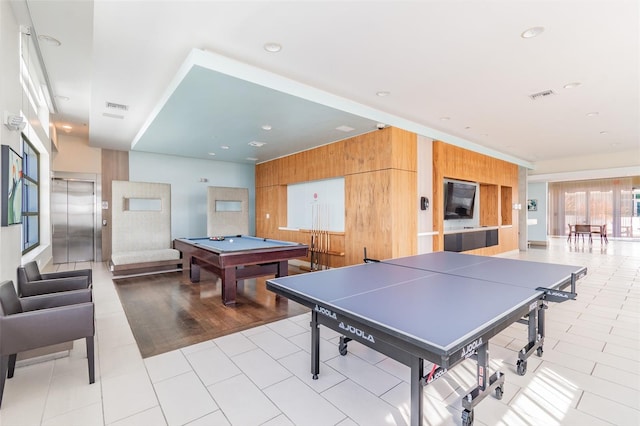 playroom featuring pool table, wood walls, visible vents, and elevator