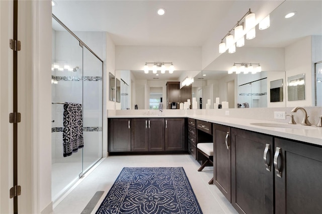 bathroom featuring tile patterned flooring, vanity, and an enclosed shower