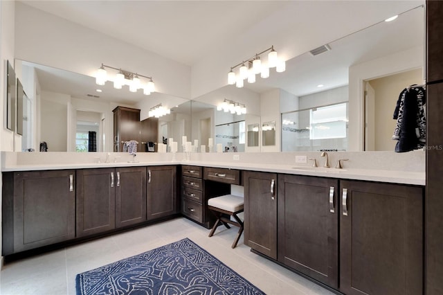 bathroom with tile patterned flooring, vanity, and a shower with door