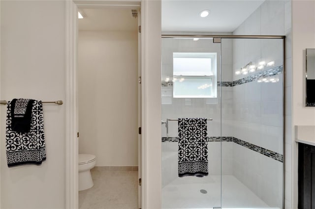 bathroom featuring tile patterned flooring, vanity, an enclosed shower, and toilet