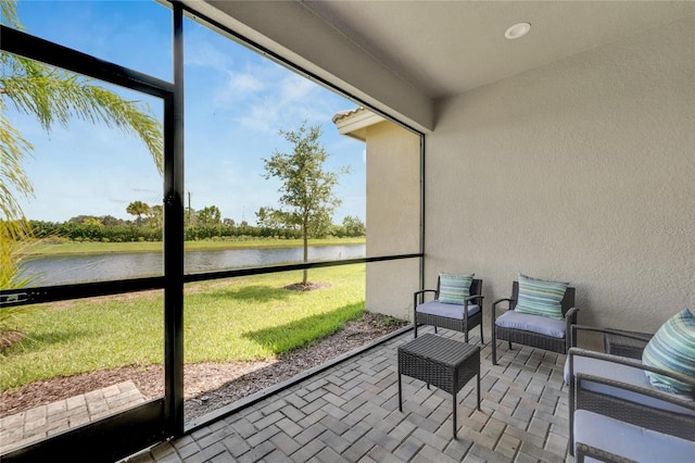 sunroom / solarium with a water view