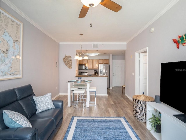 living room featuring crown molding, light hardwood / wood-style floors, and ceiling fan