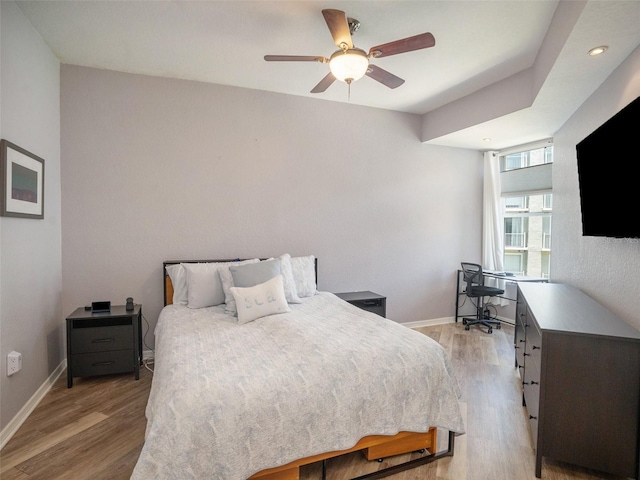 bedroom featuring light hardwood / wood-style floors and ceiling fan