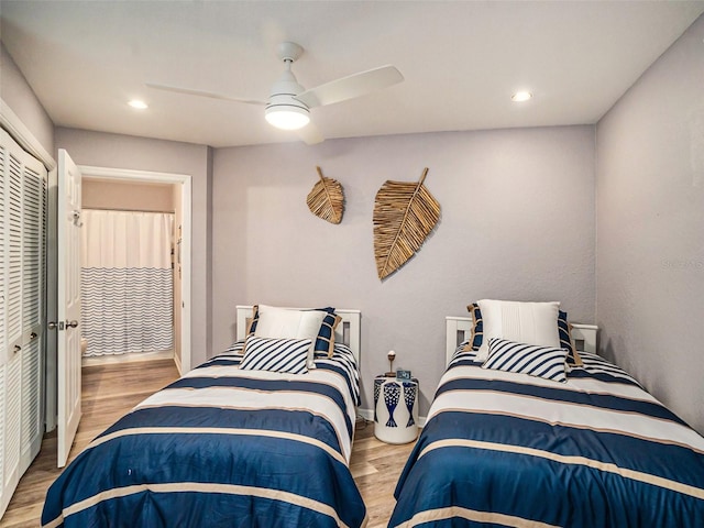 bedroom with light hardwood / wood-style flooring, a closet, and ceiling fan