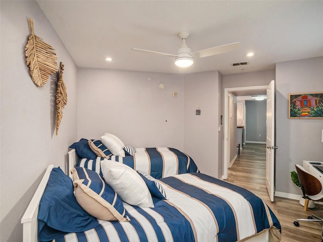 bedroom with light hardwood / wood-style flooring and ceiling fan