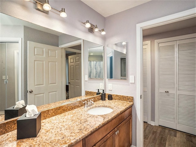 bathroom with hardwood / wood-style flooring and vanity