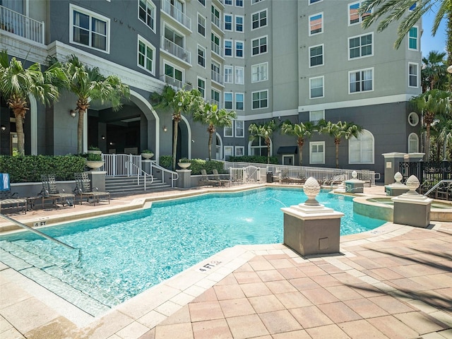 view of swimming pool featuring a patio area and pool water feature