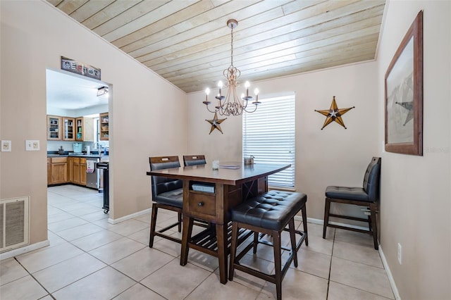 tiled dining space with an inviting chandelier and wood ceiling