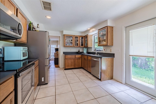 kitchen featuring stainless steel appliances and light tile patterned floors