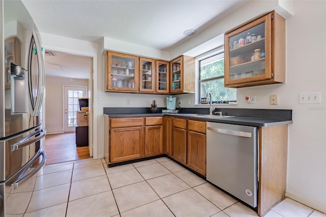 kitchen with light tile patterned floors, stainless steel appliances, and a wealth of natural light