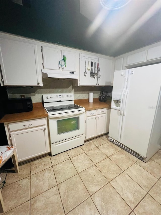 kitchen featuring light tile patterned floors, white cabinets, and white appliances