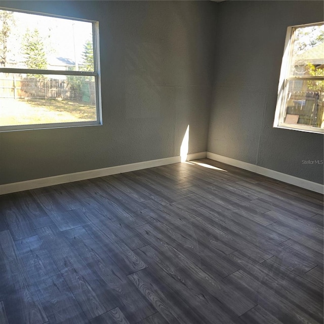 unfurnished room featuring dark hardwood / wood-style floors