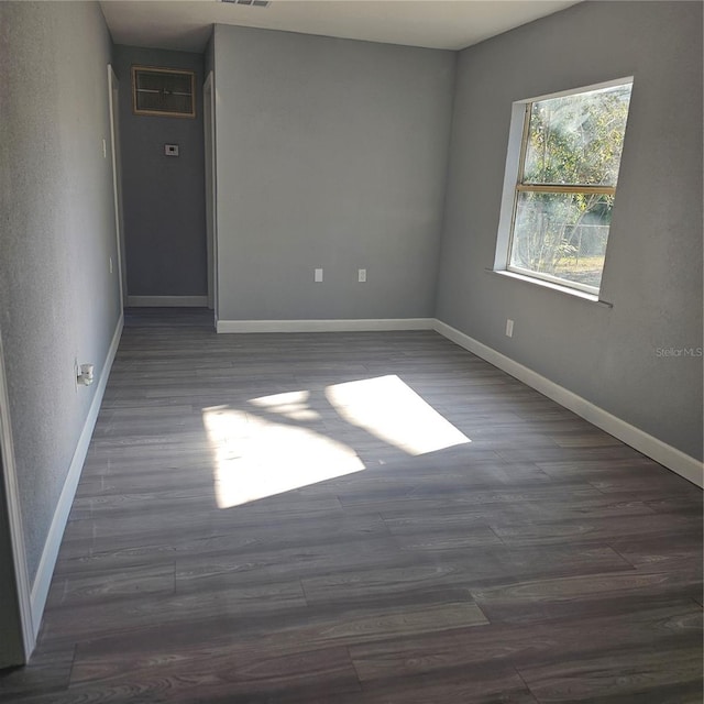 unfurnished room featuring dark hardwood / wood-style floors