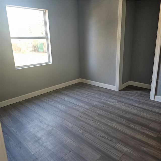 empty room with dark hardwood / wood-style floors