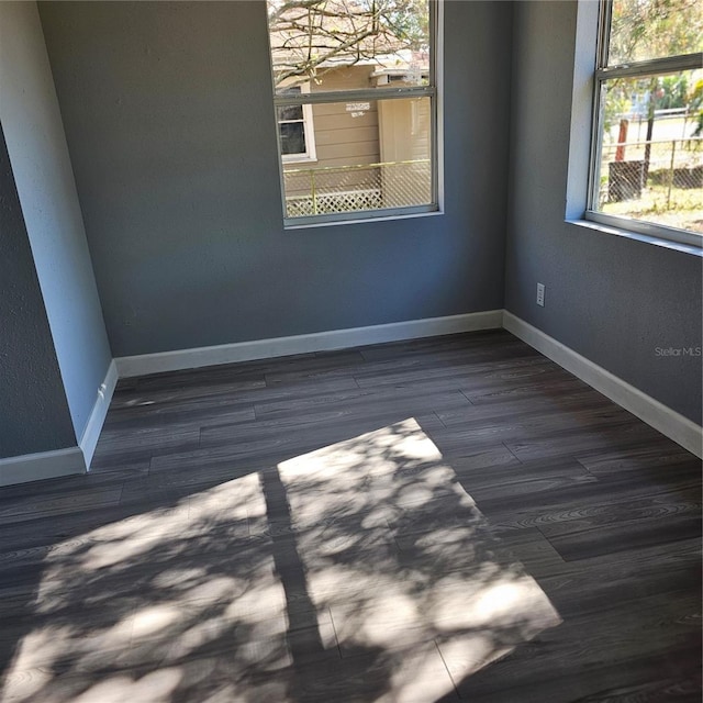 empty room with dark wood-type flooring